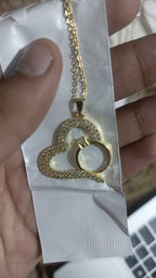 Intertwined heart and ring golden pendant necklace